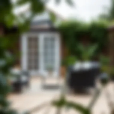 Serene Outdoor Space A serene outdoor space showcasing the black rattan loveseat and greenery